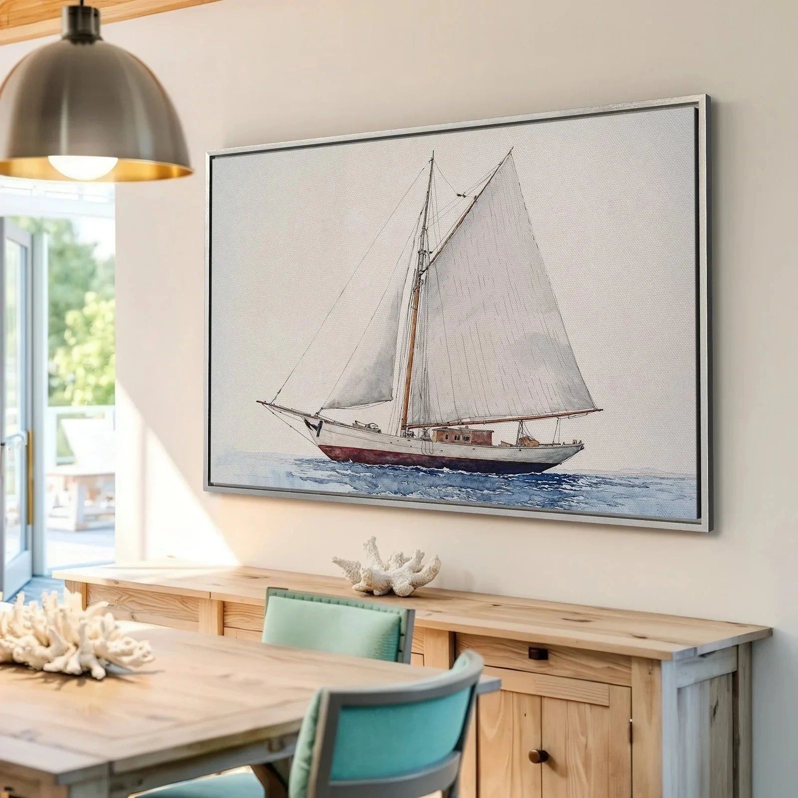 Framed sailboat painting above a dining table