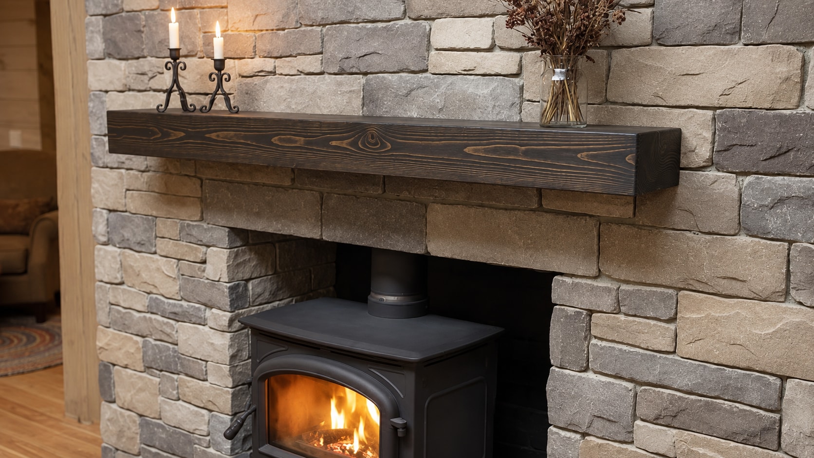 Dark wooden mantel over a wood-burning stove in a stone surround